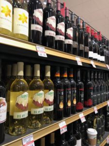 Wine bottles on retail shelf.