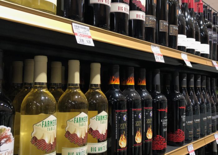 Wine bottles on retail shelf.