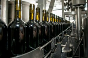 Red wine being bottled on a bottling line.